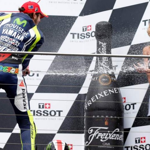 Yamaha MotoGP rider Valentino Rossi of Italy sprays a champagne girl on the podium as he celebrates his win at the Australian Grand Prix on Phillip Island October 19, 2014.     REUTERS/Jason Reed  (AUSTRALIA - Tags: SPORT MOTORSPORT)